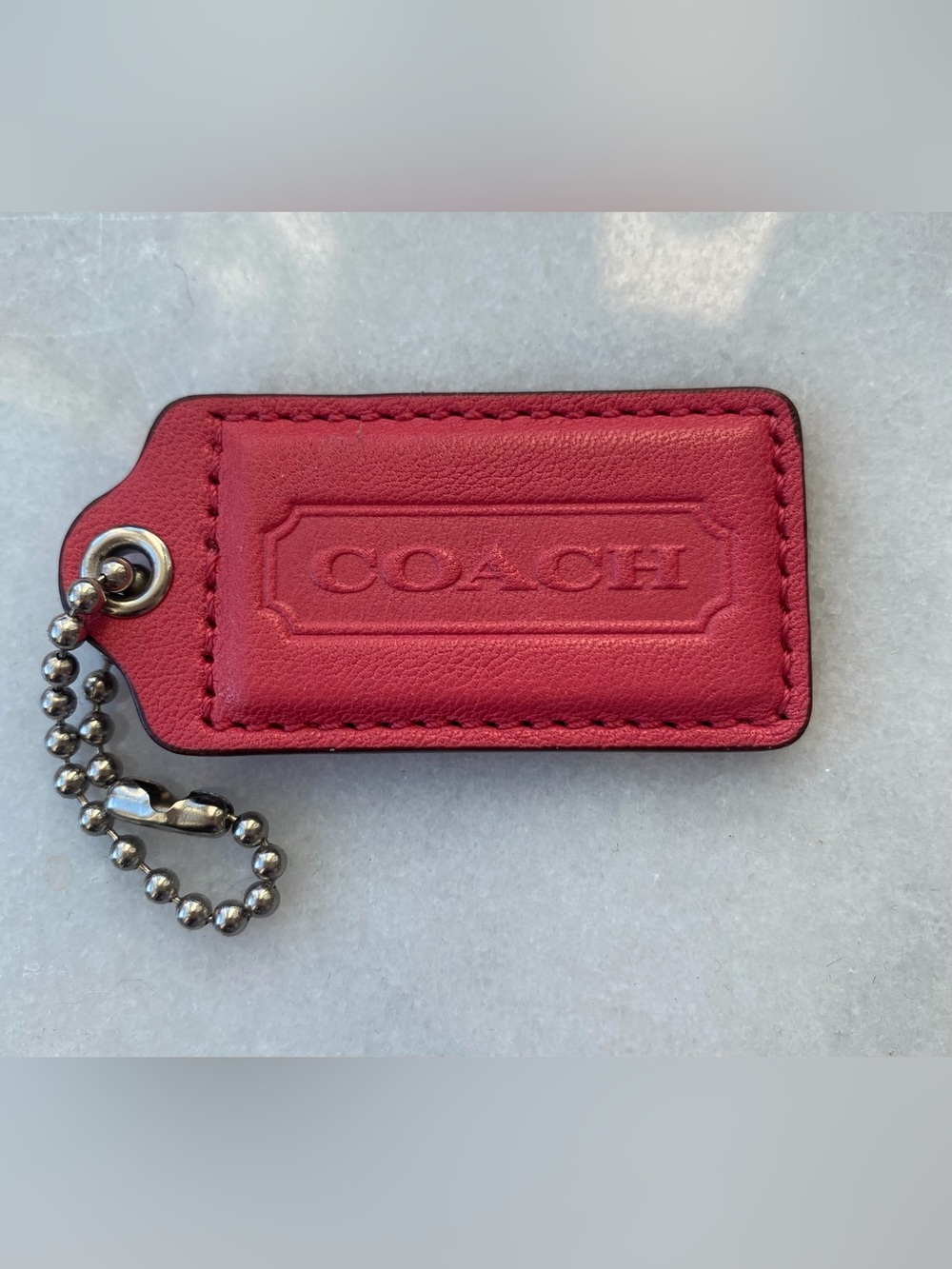 Coral rosy-pink vintage Coach leather bag tag in mint condition